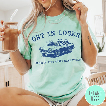Comfort Colors tee in Island Reef featuring vintage style graphic of three raccoons driving a convertible car