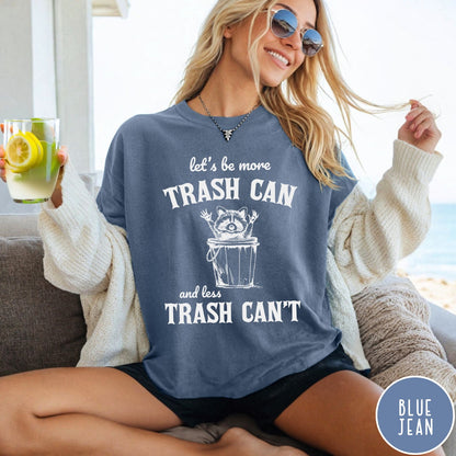 Comfort Colors tee in Blue Jean featuring casual graphic style with a raccoon inside a trash can illustration