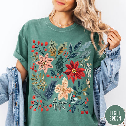 Comfort Colors tee in Light Green featuring winter florals graphic with poinsettias, holly leaves, and red berries.
