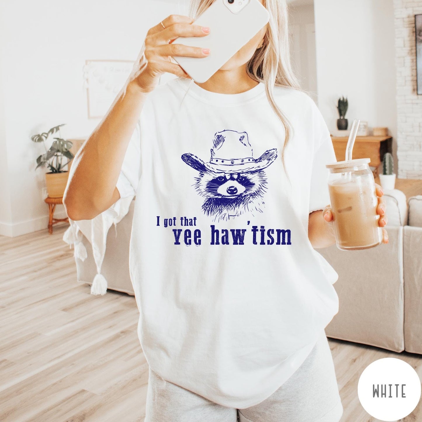Comfort Colors tee in White featuring western style graphic of a raccoon wearing a cowboy hat