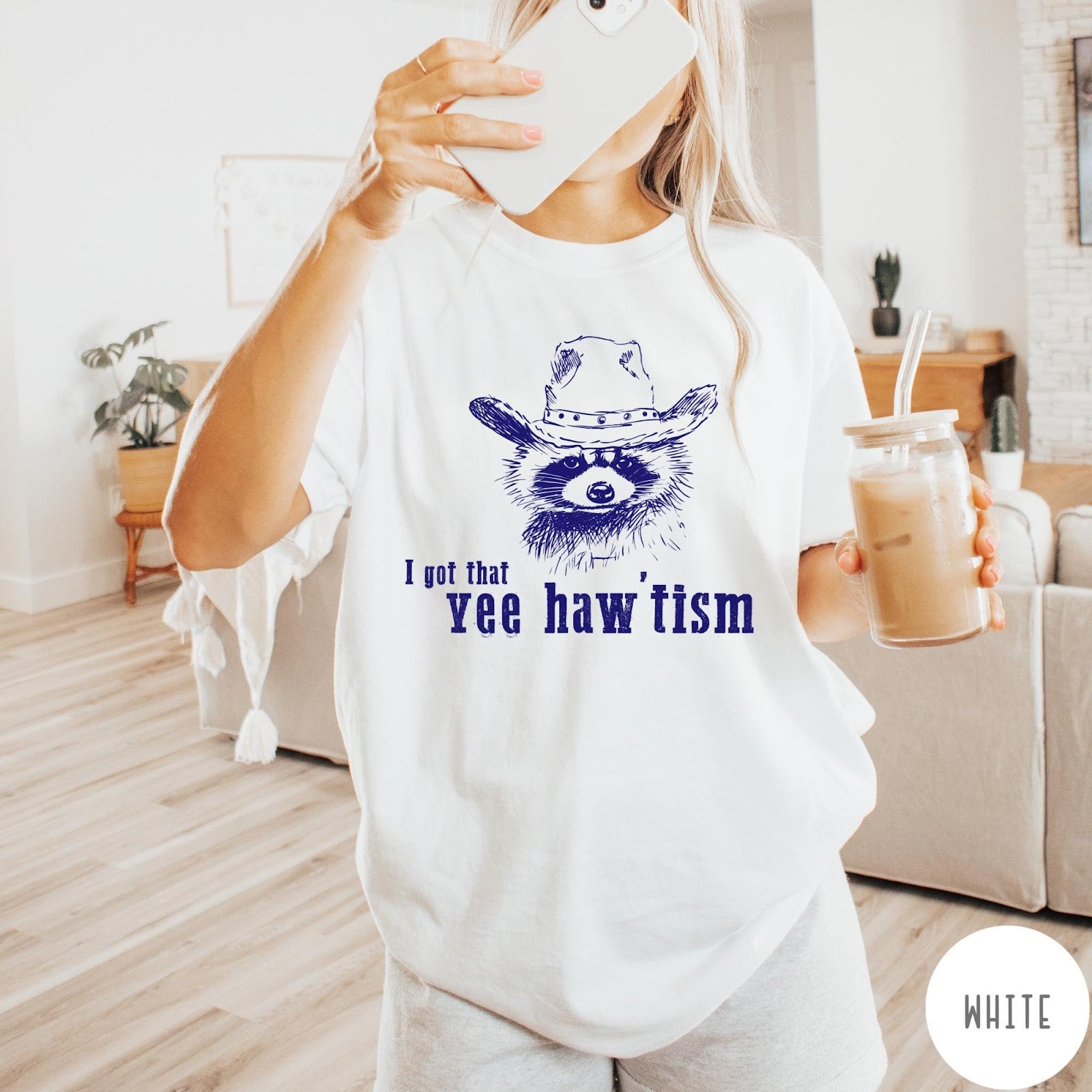Comfort Colors tee in White featuring western style graphic of a raccoon wearing a cowboy hat