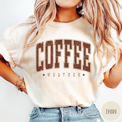 Comfort Colors tee in Ivory featuring collegiate style Coffee Weather graphic with distressed brown text and stars