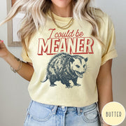 Comfort Colors tee in Butter featuring screen printed opossum graphic with text I could be meaner