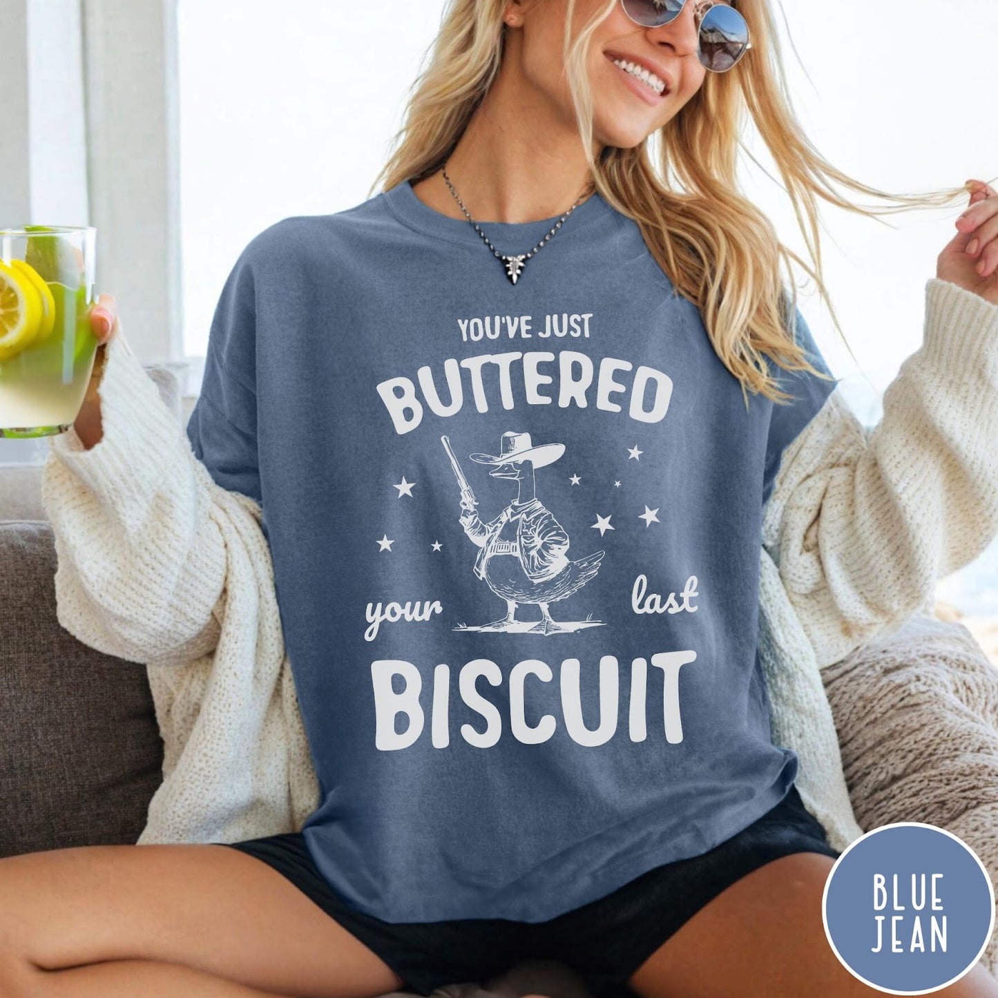 Comfort Colors tee in Blue Jean featuring western graphic style cowboy goose holding a revolver with star accents