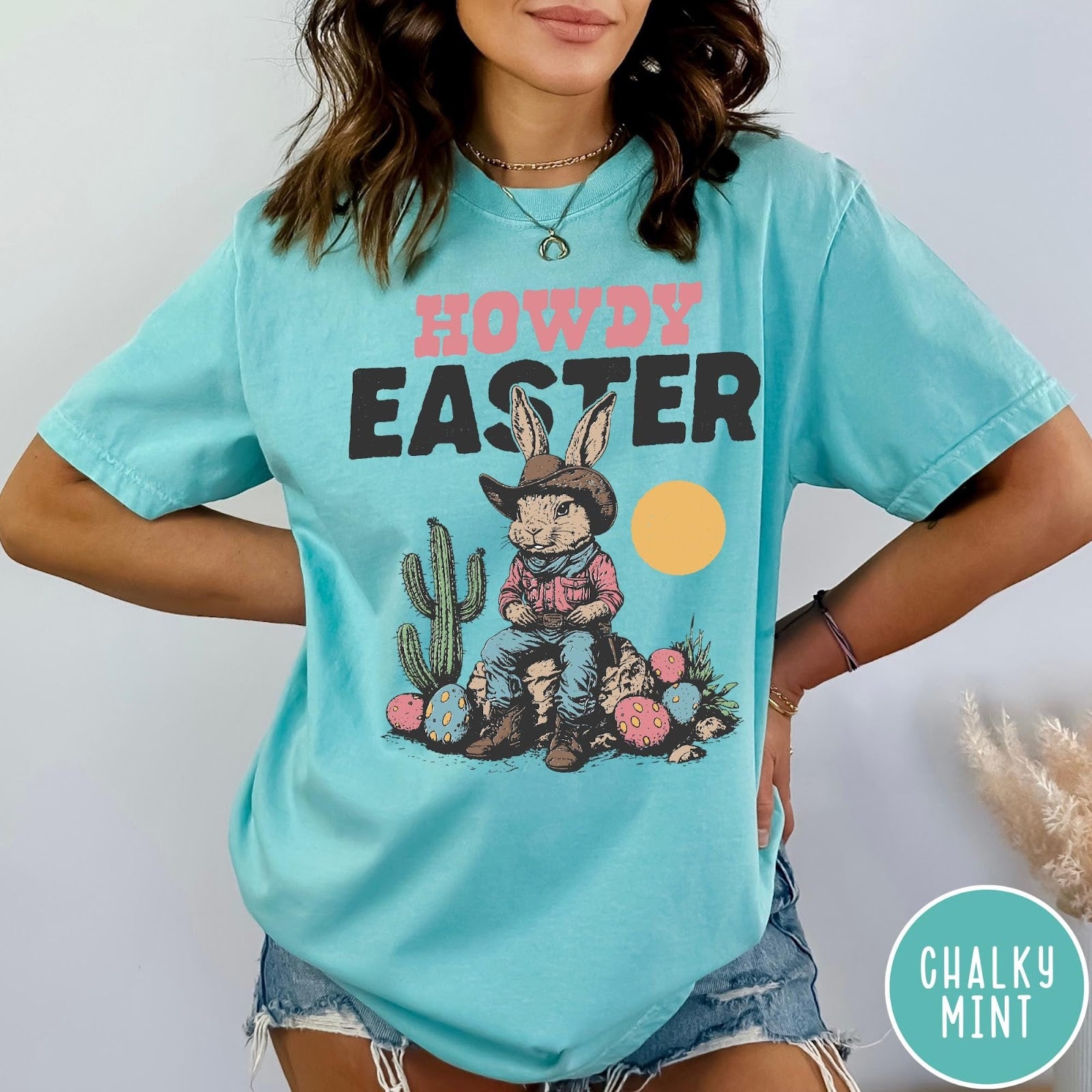 Comfort Colors tee in Chalky Mint featuring western design style cowboy bunny sitting on a rock with cactus