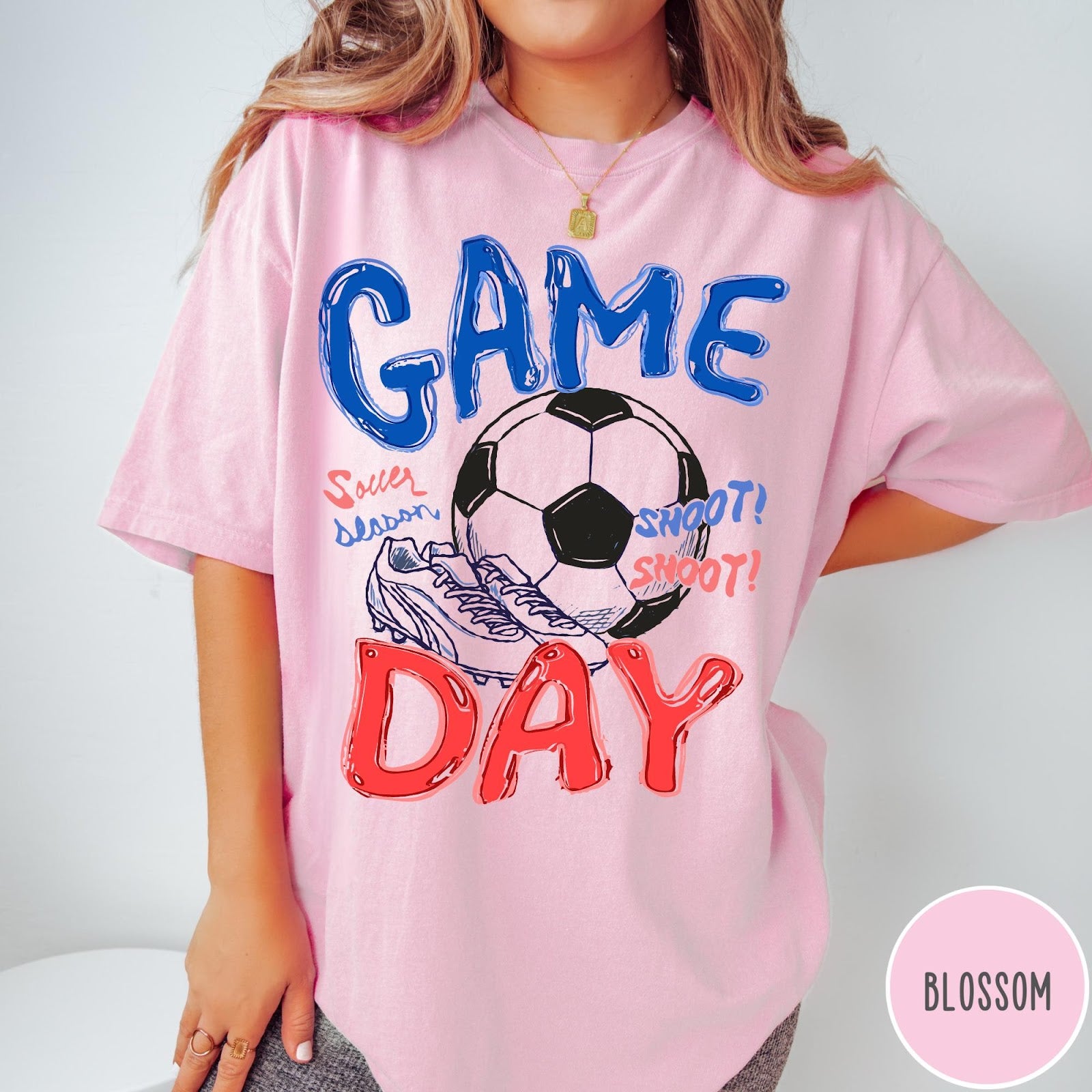 Comfort Colors tee in Blossom featuring soccer graphic with ball, cleats, and Game Day typography design
