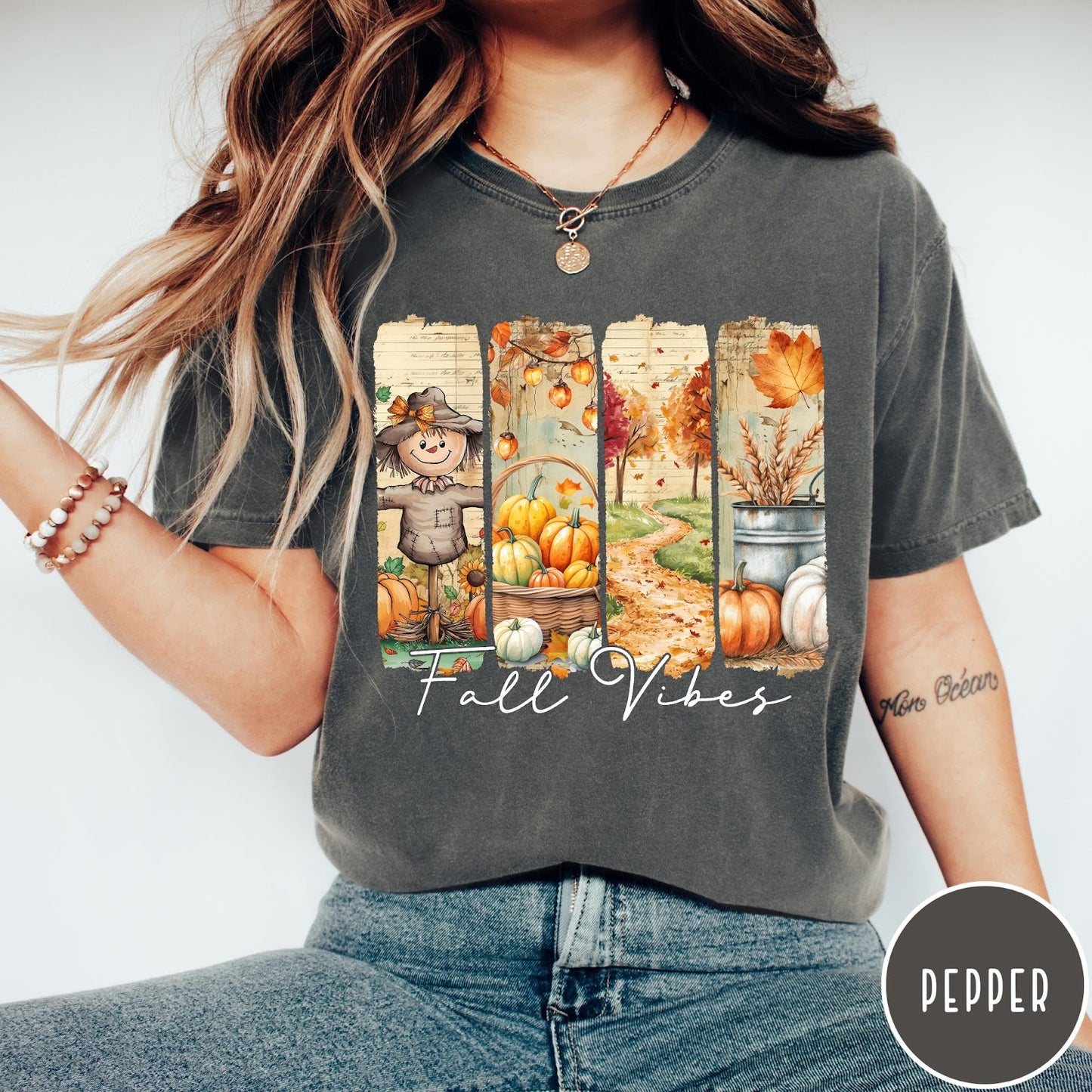 Comfort Colors tee in Pepper featuring autumn harvest graphic with a scarecrow, pumpkins, and fall foliage scenes