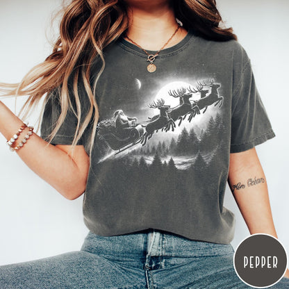 Comfort Colors tee in Pepper featuring vintage style graphic of Santa Claus flying his sleigh with reindeer
