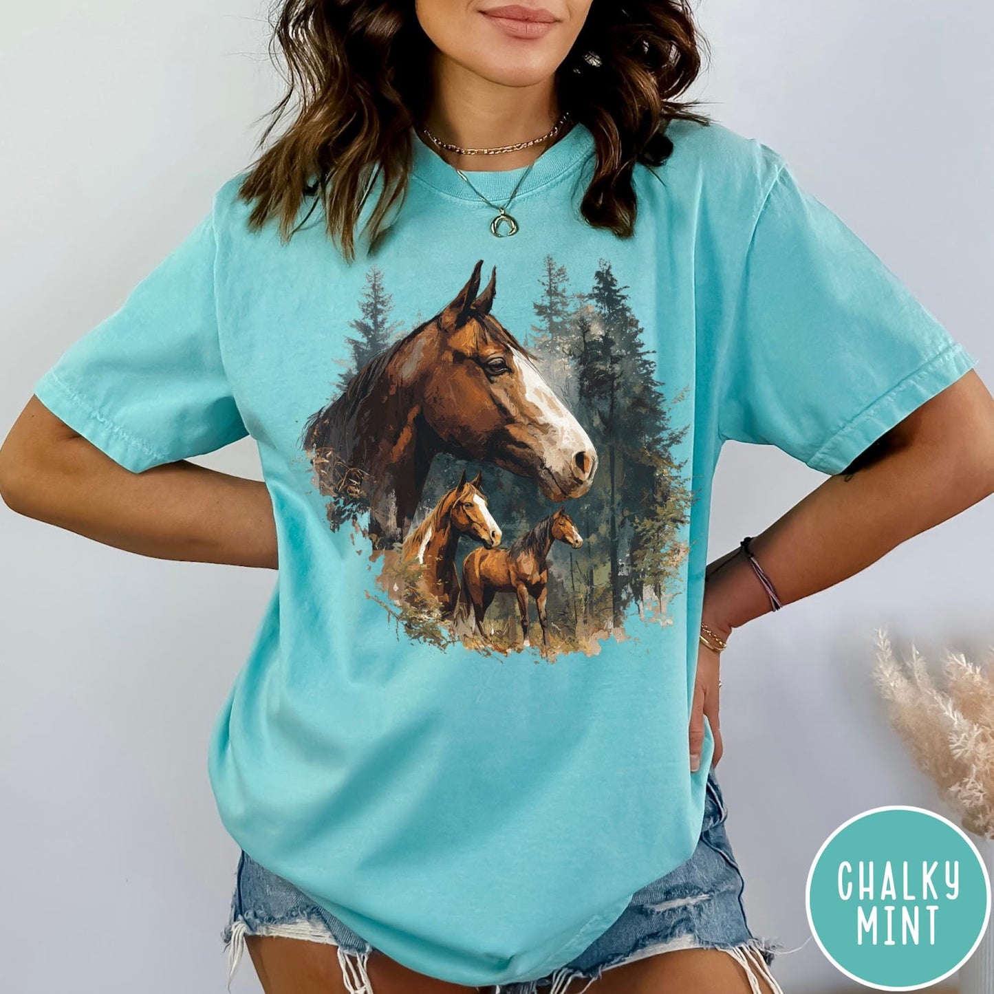 Comfort Colors tee in Chalky Mint featuring vintage style graphic of three horses standing in a pine forest