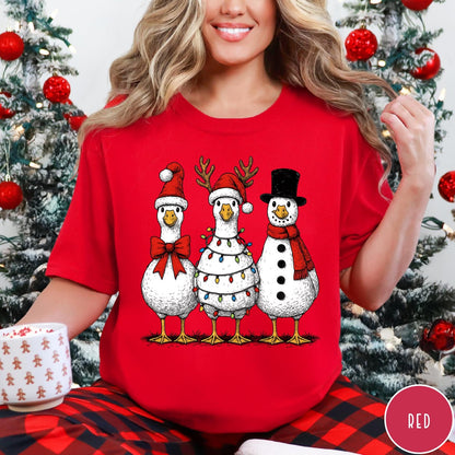 Comfort Colors tee in Red featuring festive holiday graphic of three geese dressed as Santa and snowman