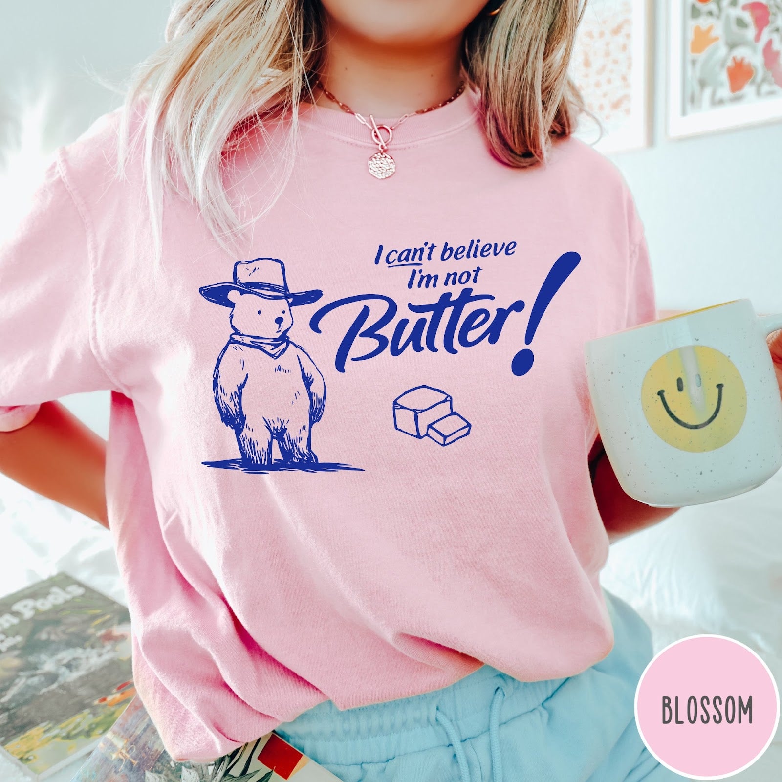 Comfort Colors tee in Blossom featuring bear graphic with cowboy hat and text I can't believe I'm not Butter