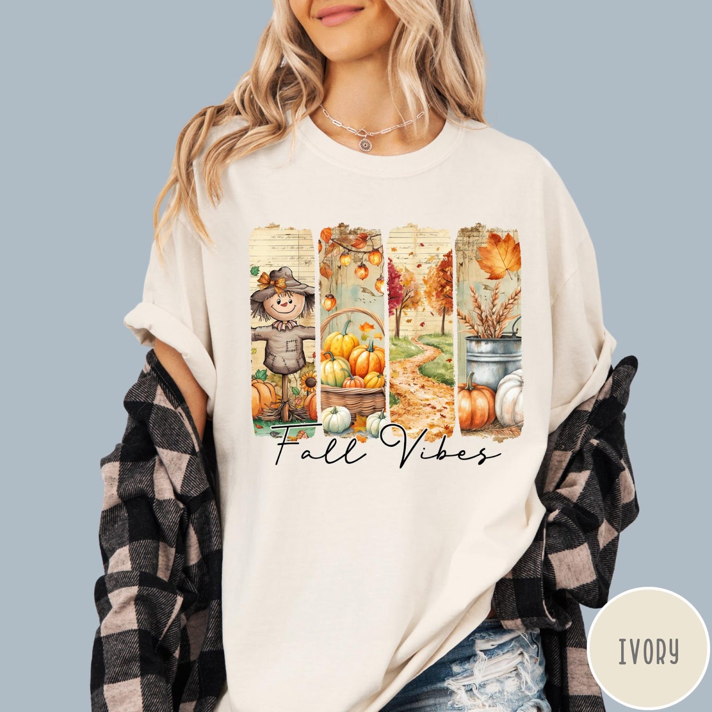 Comfort Colors tee in Ivory featuring autumn harvest graphic with a scarecrow, pumpkins, and fall foliage scenes