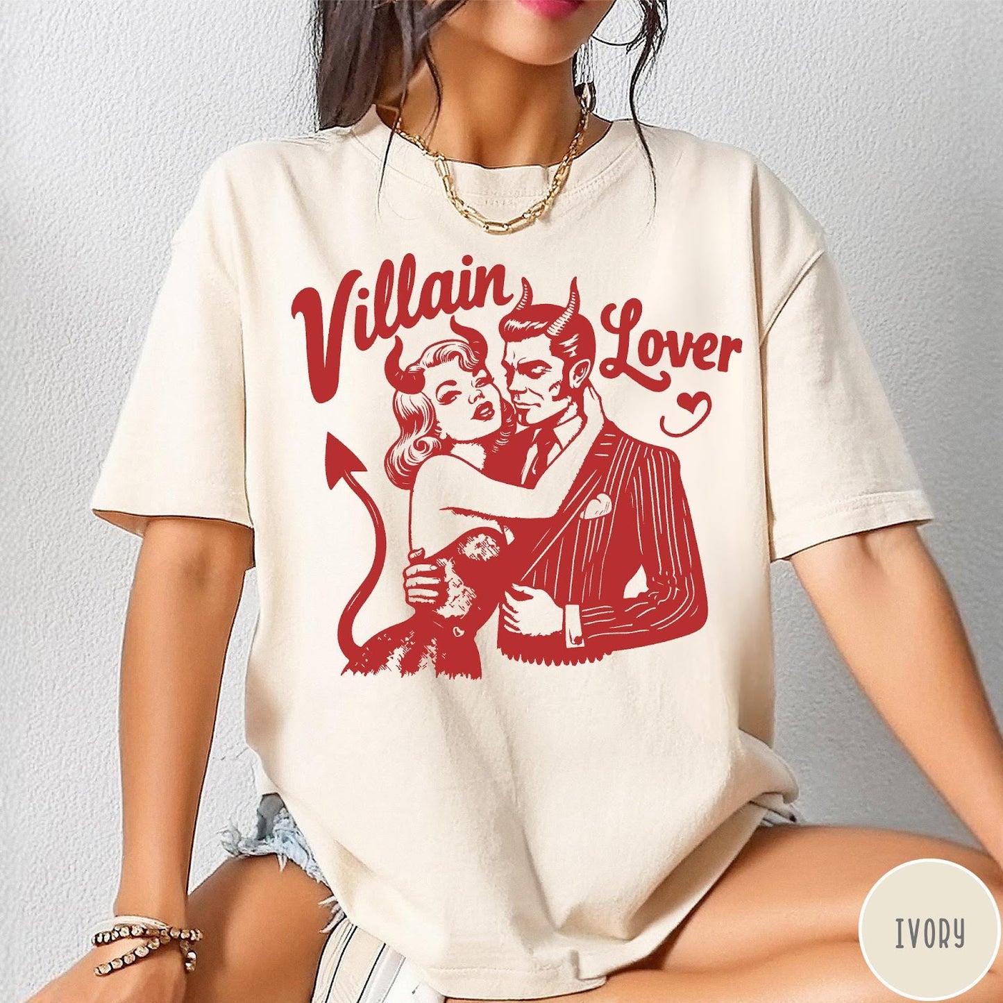 Comfort Colors tee in Ivory featuring vintage style graphic of a devilish couple embracing with red ink