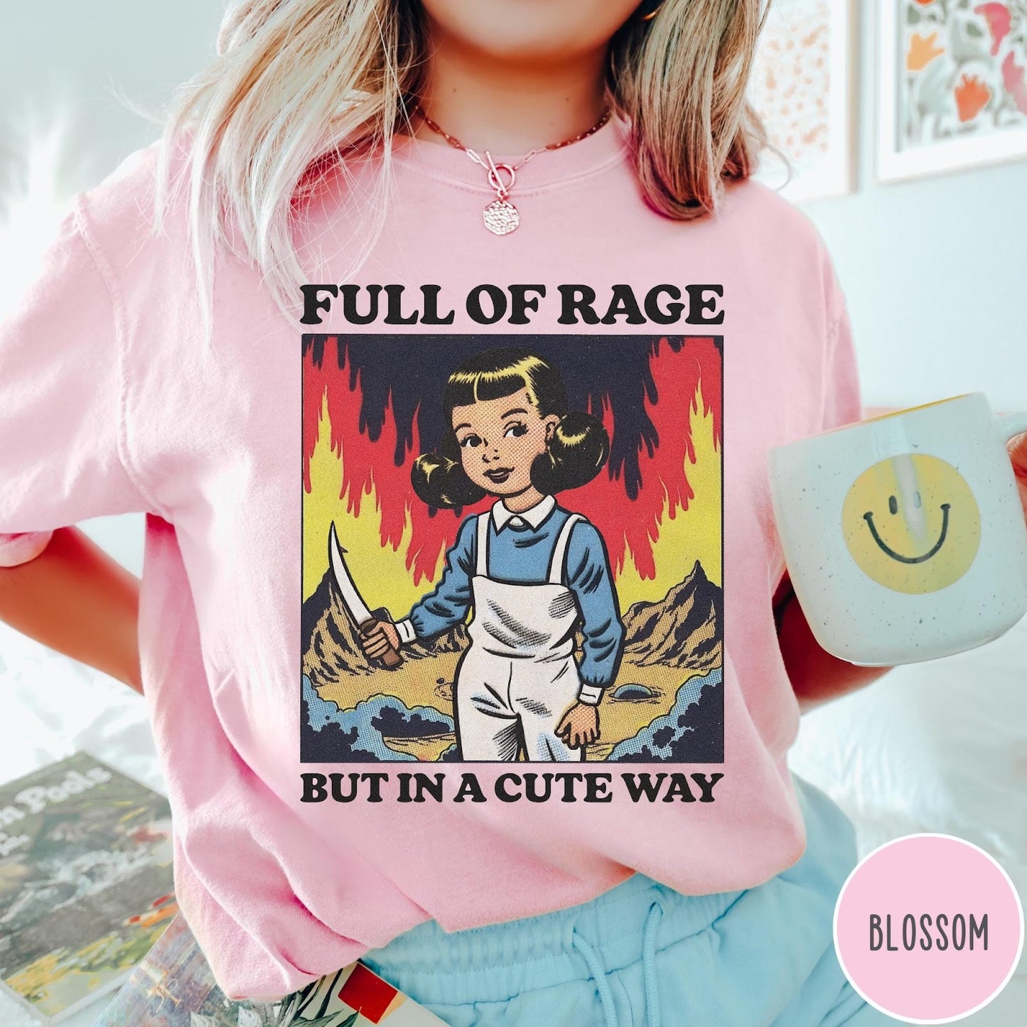 Comfort Colors tee in Blossom featuring cartoon style graphic of a girl holding a knife in flames