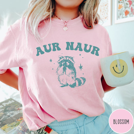 Comfort Colors tee in Blossom featuring retro style graphic of a raccoon with stars and text