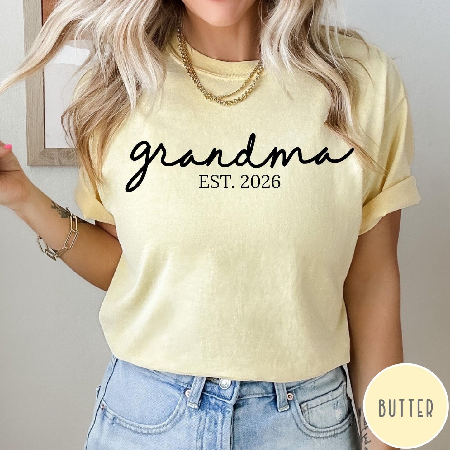 Comfort Colors tee in Butter featuring cursive Grandma Est 2026 text in a clean black graphic style