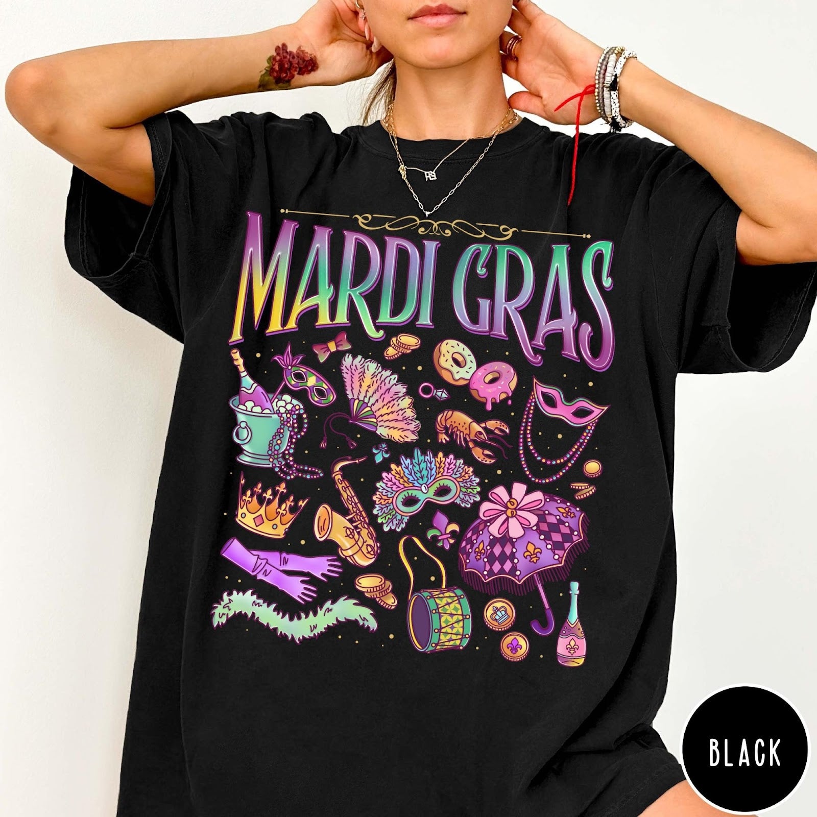 Comfort Colors tee in Black featuring vintage style Mardi Gras celebration icons including masks, beads, and saxophone