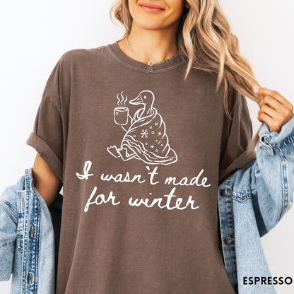 Comfort Colors tee in Espresso featuring line art graphic of a duck wrapped in a blanket drinking coffee