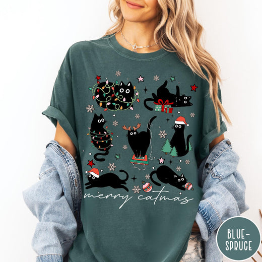 Comfort Colors tee in Blue Spruce featuring festive holiday graphic with multiple black cats and Christmas elements