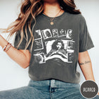 Comfort Colors tee in Pepper featuring graphic style illustration of a woman sleeping surrounded by horror polaroids