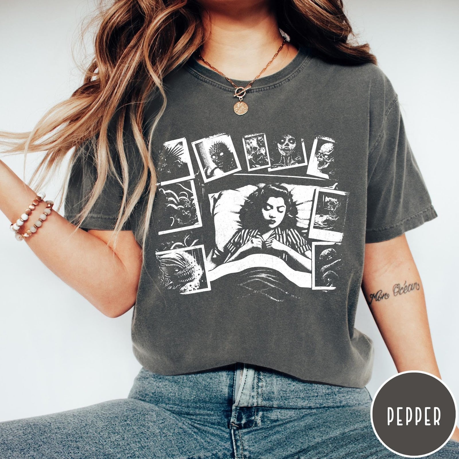 Comfort Colors tee in Pepper featuring graphic style illustration of a woman sleeping surrounded by horror polaroids