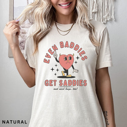 Comfort Colors tee in Natural featuring retro style sad heart character with horns and text graphic