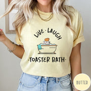 Comfort Colors tee in Butter featuring cute graphic style of a smiling toaster sitting in a bathtub
