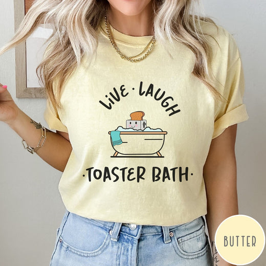 Comfort Colors tee in Butter featuring cute graphic style of a smiling toaster sitting in a bathtub