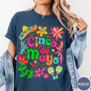 Comfort Colors tee in Midnight featuring festive Cinco de Mayo graphic with sombrero, maracas, and colorful flowers