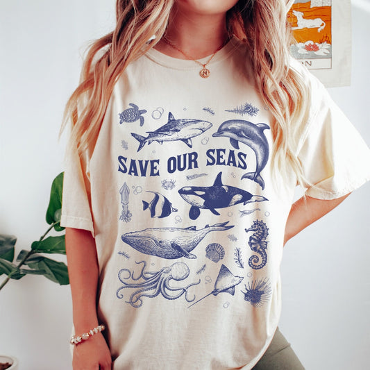 Comfort Colors tee in Ivory featuring marine life graphic design with various sea creatures and Save Our Seas text