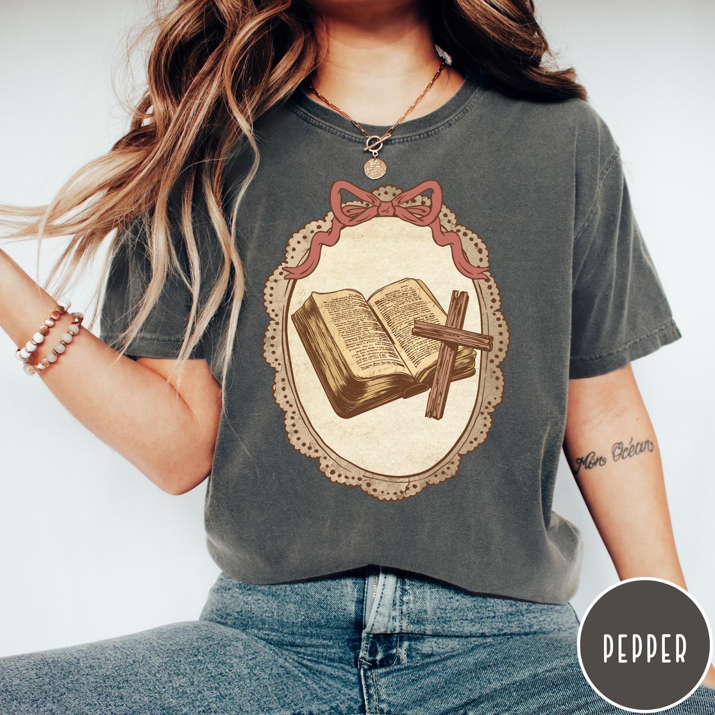 Comfort Colors tee in Pepper featuring vintage style graphic of an open Bible and wooden cross