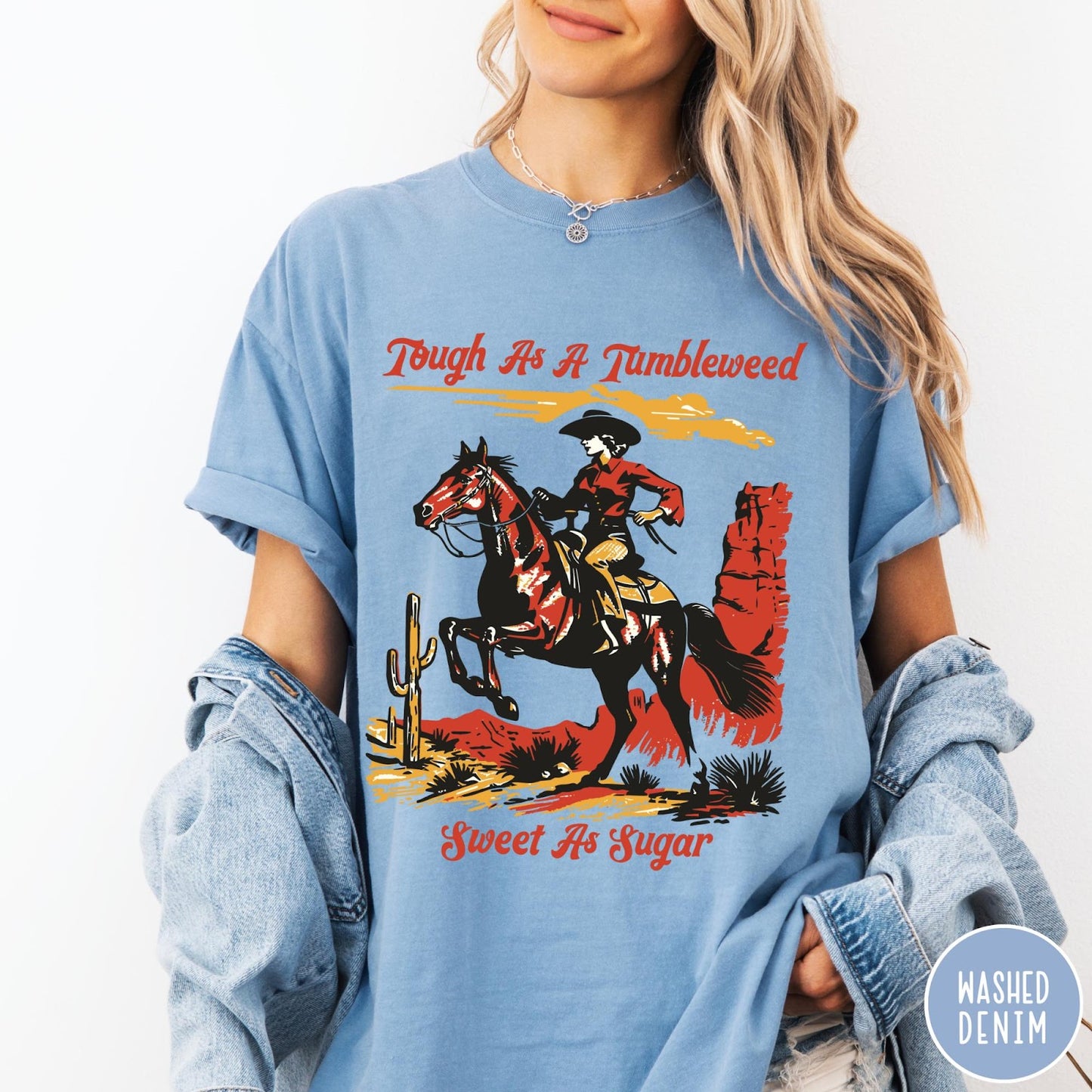 Comfort Colors tee in Washed Denim featuring western style graphic of a cowgirl riding a horse in desert
