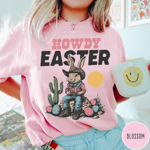 Comfort Colors tee in Blossom featuring western design style cowboy bunny sitting on a rock with cactus