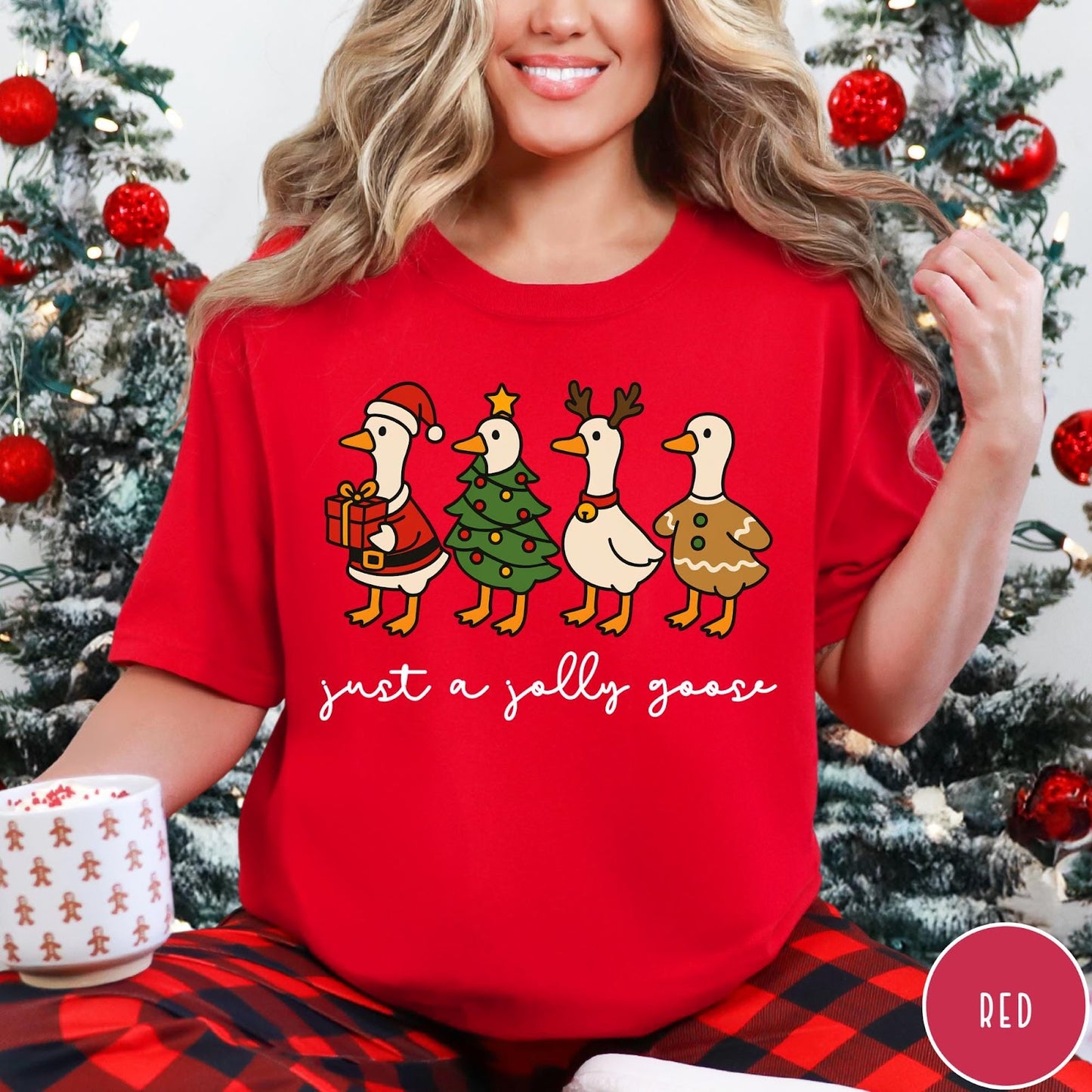 Comfort Colors tee in Red featuring festive geese graphic with Santa, Christmas tree, reindeer, and gingerbread goose designs