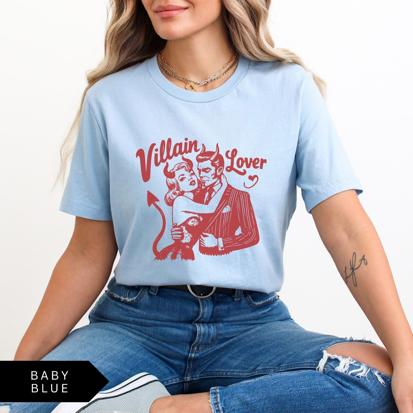 Comfort Colors tee in Baby Blue featuring vintage style graphic of a devilish couple embracing with text Villain Lover