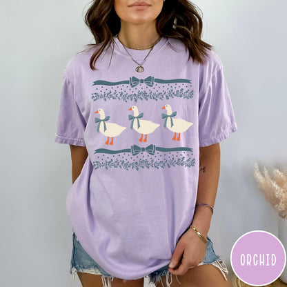 Comfort Colors tee in Orchid featuring vintage style graphic with three geese wearing blue ribbons and floral borders