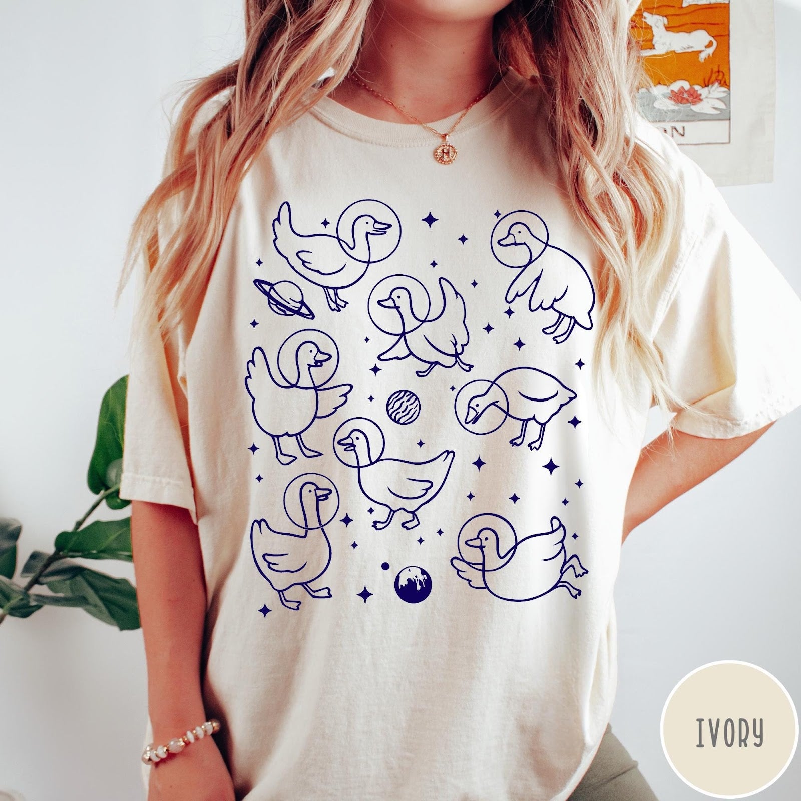 Comfort Colors tee in Ivory featuring line art graphic of multiple geese wearing astronaut helmets in space