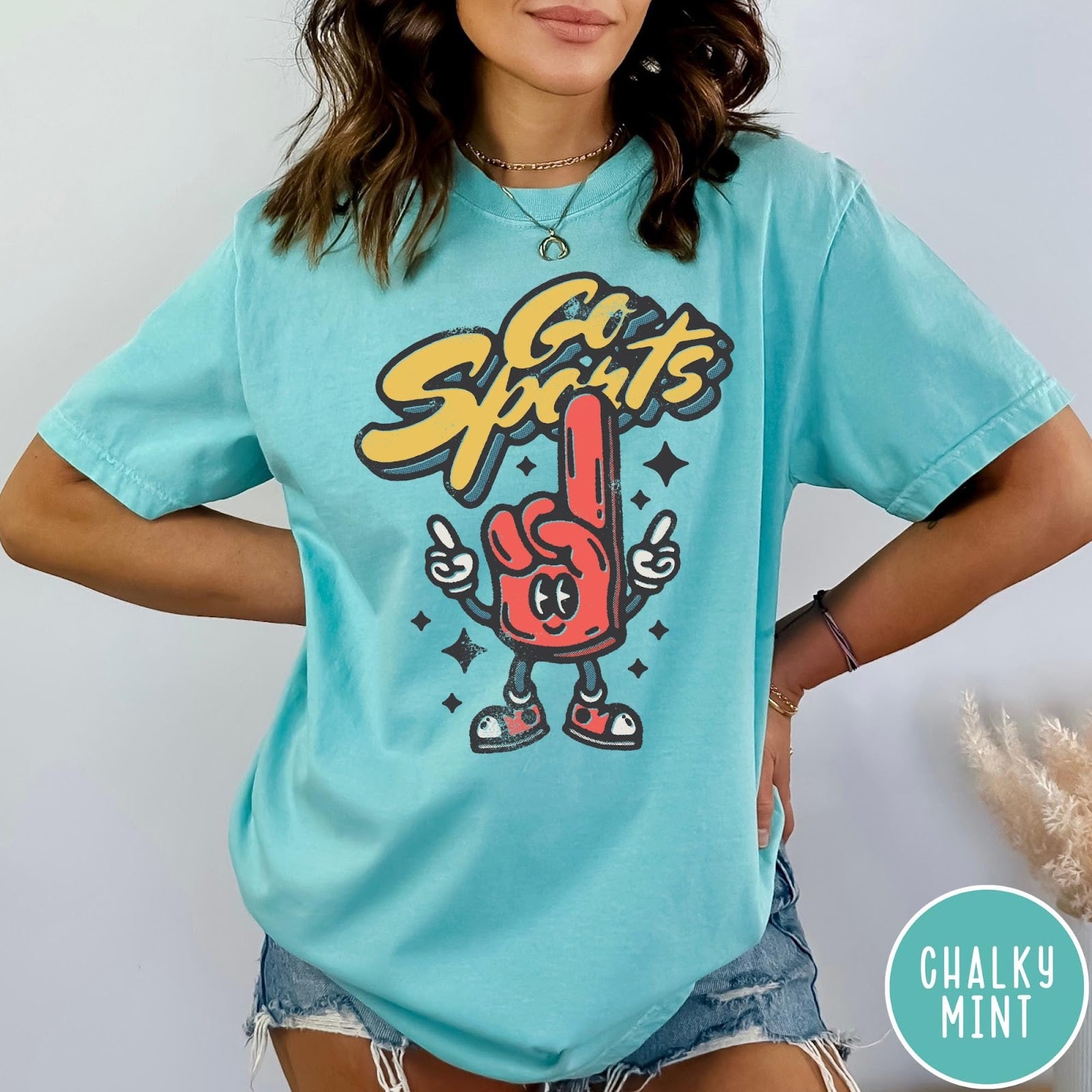Comfort Colors tee in Chalky Mint featuring retro mascot design with a red foam finger and Go Sports text