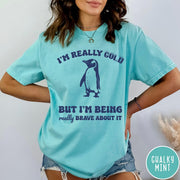Comfort Colors tee in Chalky Mint featuring penguin graphic with text I am really cold but I am brave