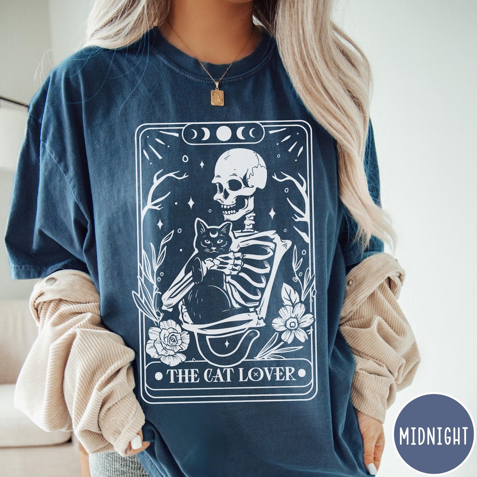 Comfort Colors tee in Midnight featuring tarot style graphic of a skeleton holding a black cat