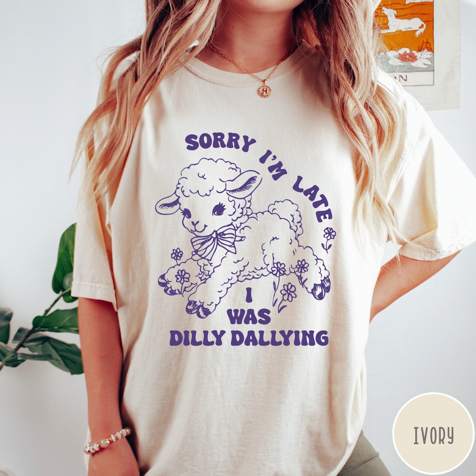 Comfort Colors tee in Ivory featuring line art graphic of a lamb with flowers and text