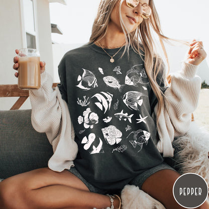 Comfort Colors tee in Pepper featuring coastal style graphic with various tropical fish and ocean life illustrations