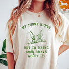 Comfort Colors tee in Ivory featuring line art graphic of a bunny with text My Tummy Hurts