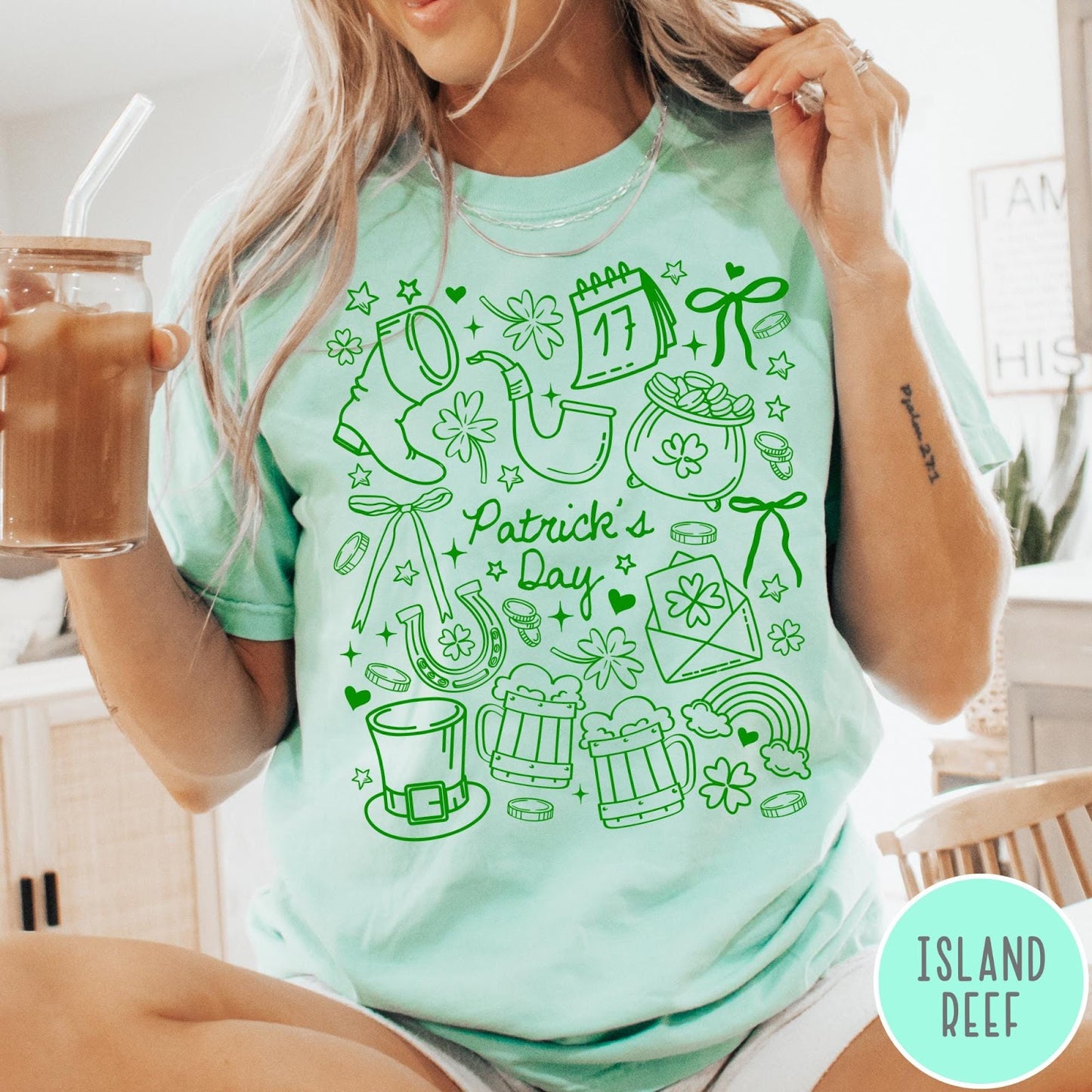 Comfort Colors tee in Island Reef featuring line art style St. Patrick's Day icons including shamrocks and leprechaun hat