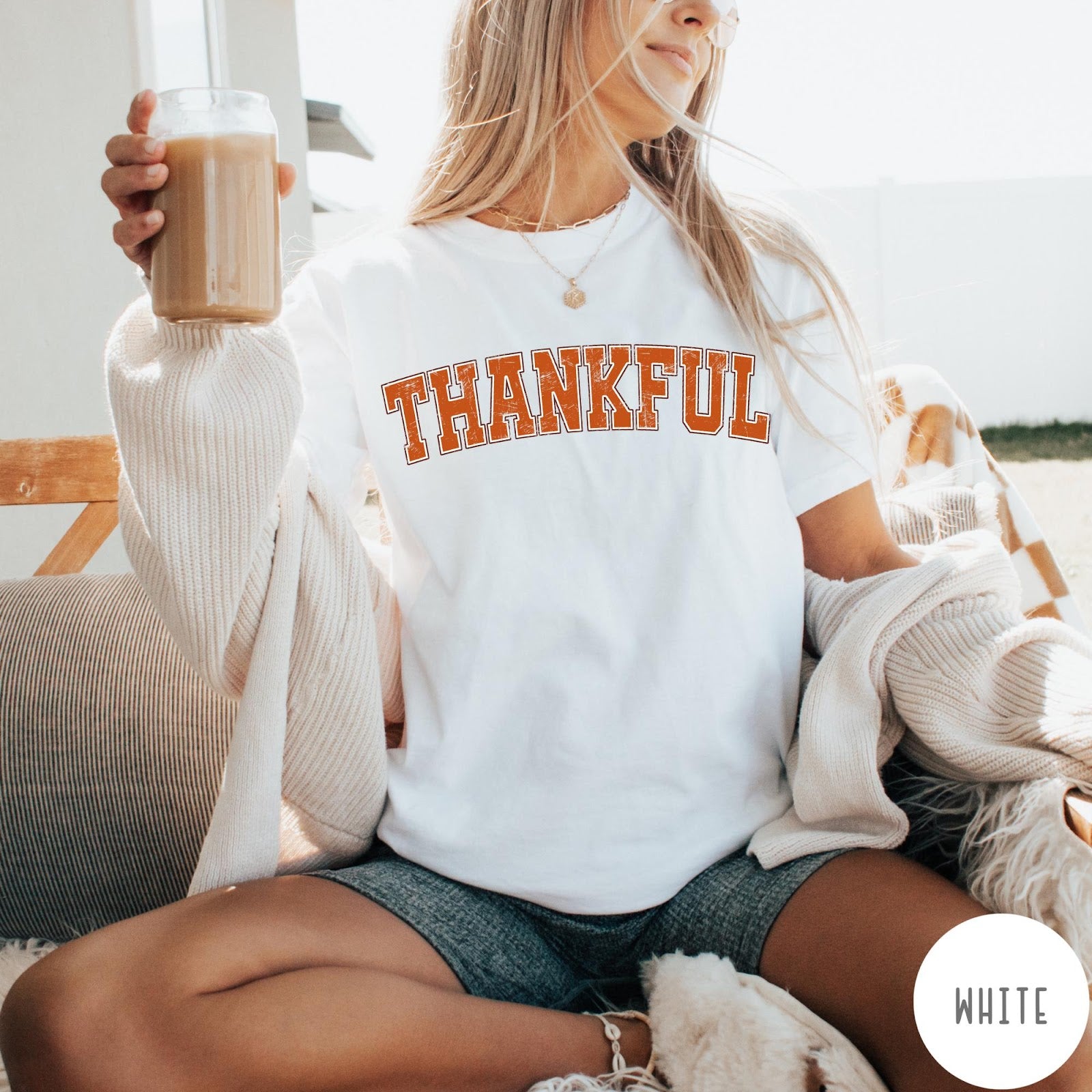 Comfort Colors tee in White featuring typography graphic with the word Thankful in an arched varsity style