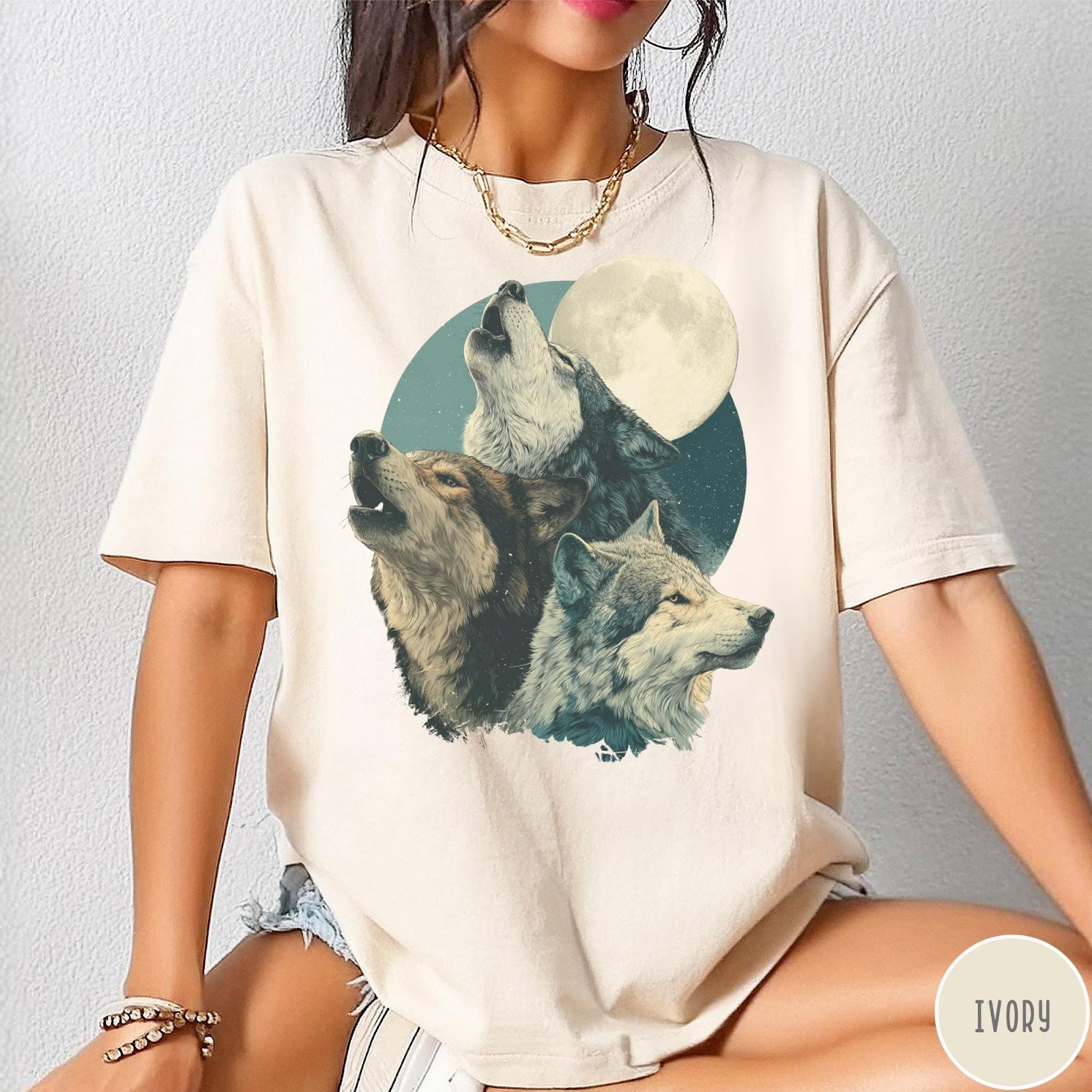 Comfort Colors tee in Ivory featuring vintage style graphic of three howling wolves under a full moon