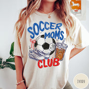 Comfort Colors tee in Ivory featuring soccer mom lifestyle graphic with soccer ball, cleats, and iced coffee