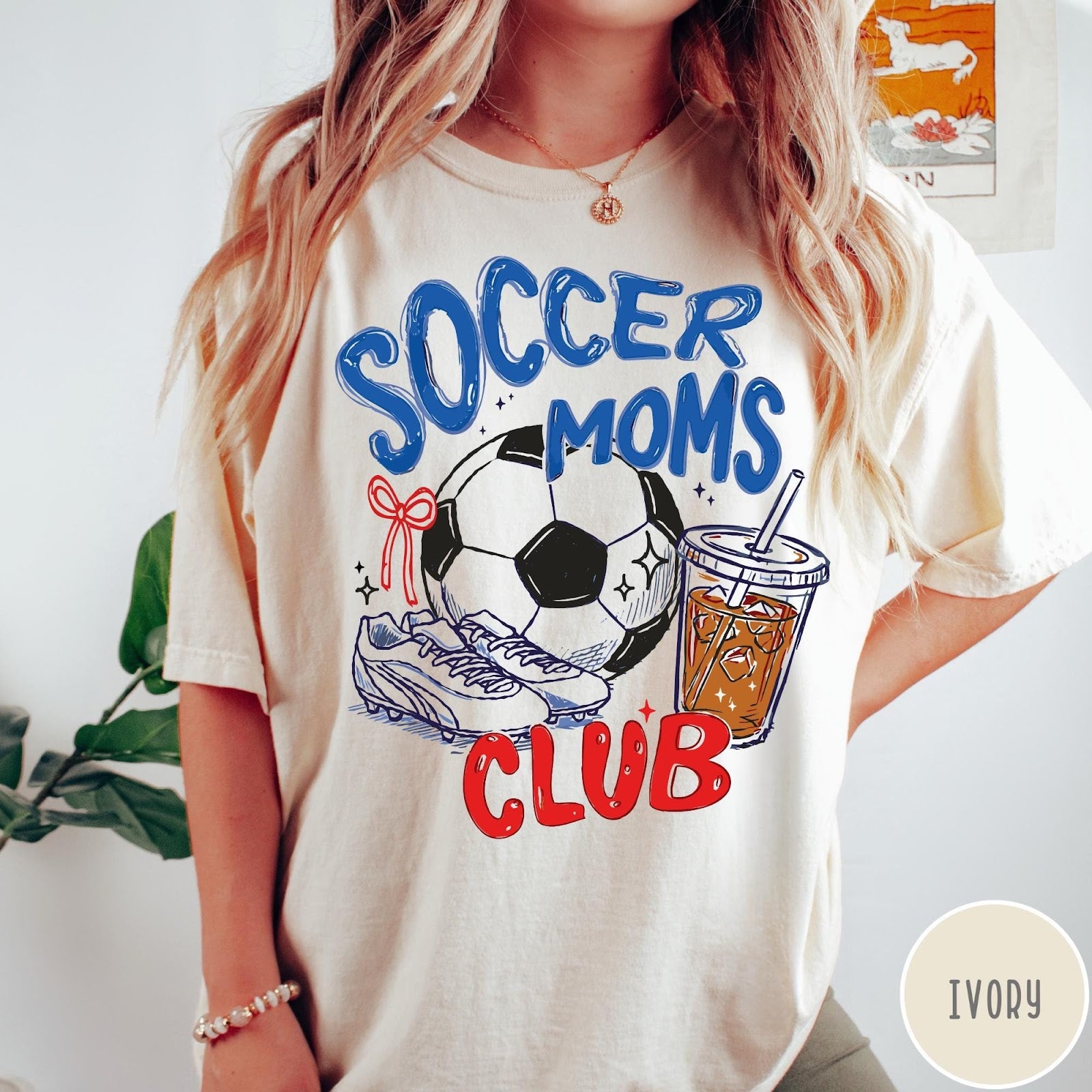 Comfort Colors tee in Ivory featuring soccer mom lifestyle graphic with soccer ball, cleats, and iced coffee
