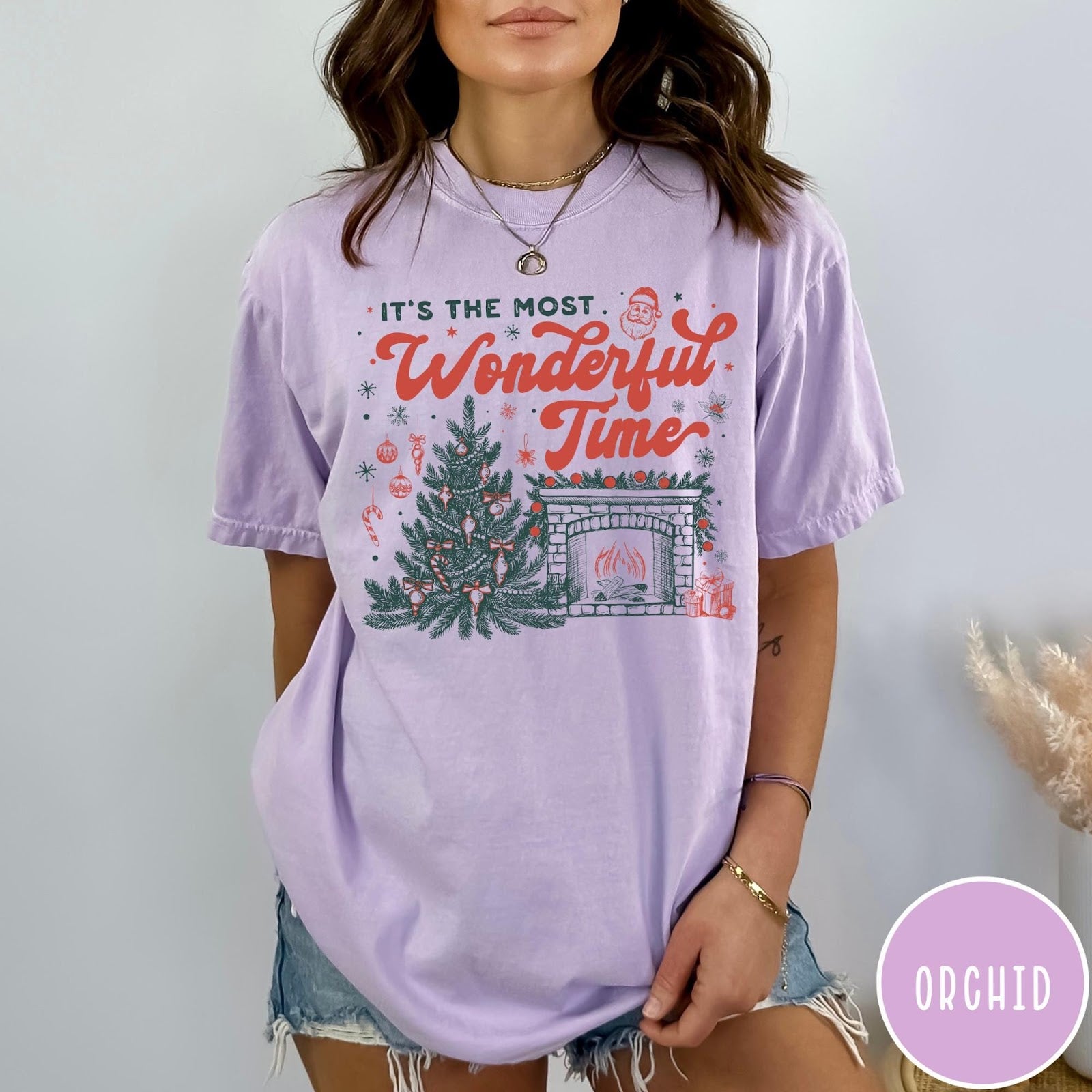 Comfort Colors tee in Orchid featuring Christmas design with a decorated tree and a cozy fireplace scene