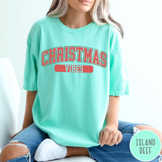Comfort Colors tee in Island Reef featuring Christmas holiday theme graphic with red and green text design